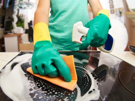 Cleaning technician assessing carpet condition before treatment