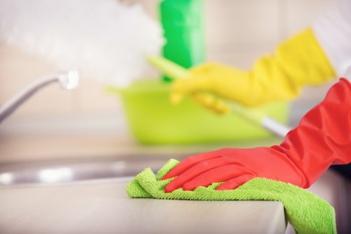 Cleaner working on a built-in oven in a SE17 kitchen